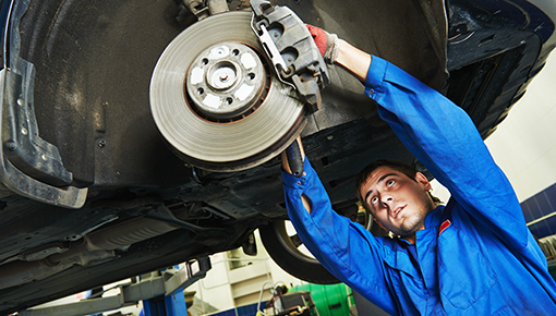 Service technician changing brake pads